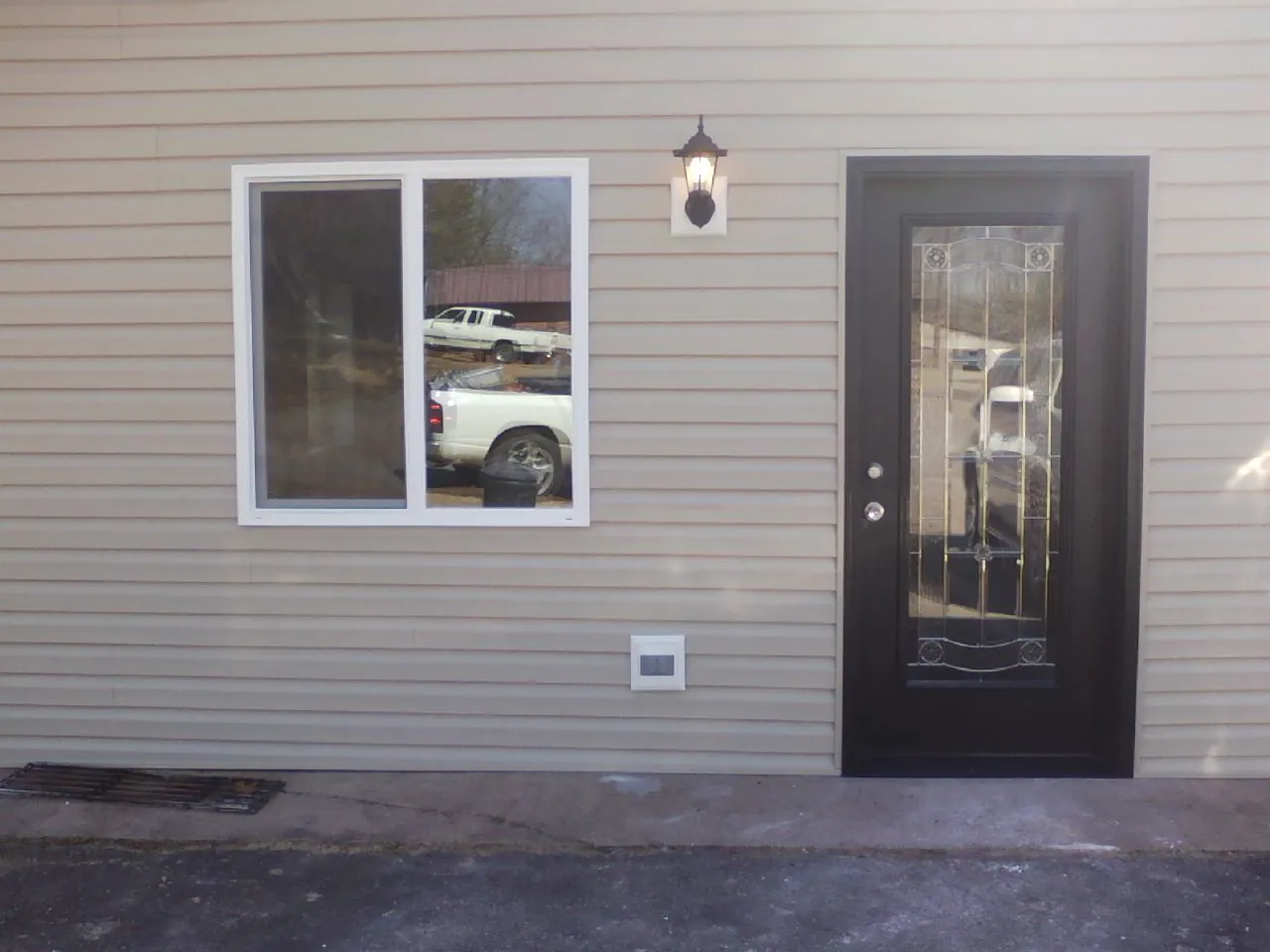 New siding, window and entry door on the side of an addition in Ehrhardt