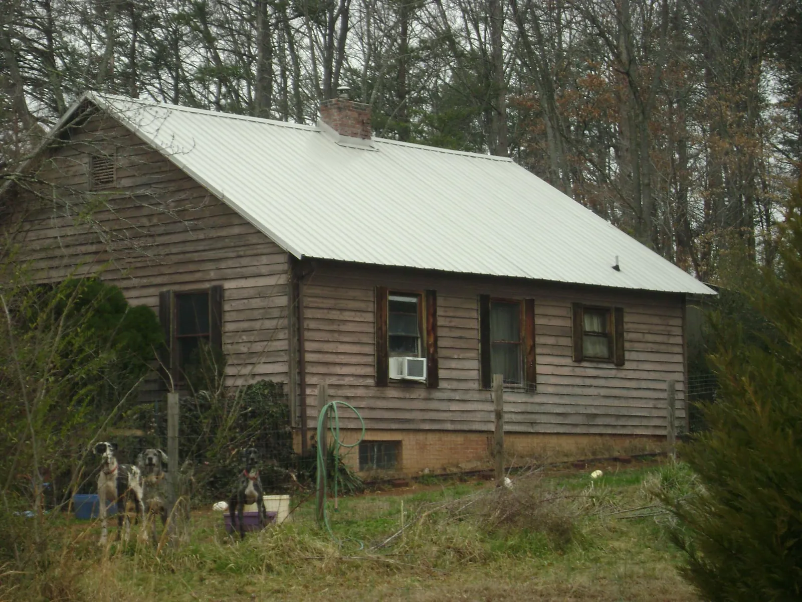 White metal roof on an old wood sided farmhouse, from a Metal Roof Installation job in Ehrhardt